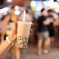 Asian,Woman,Holding,The,Famous,Taiwanese,Bubble,Milk,Tea,At